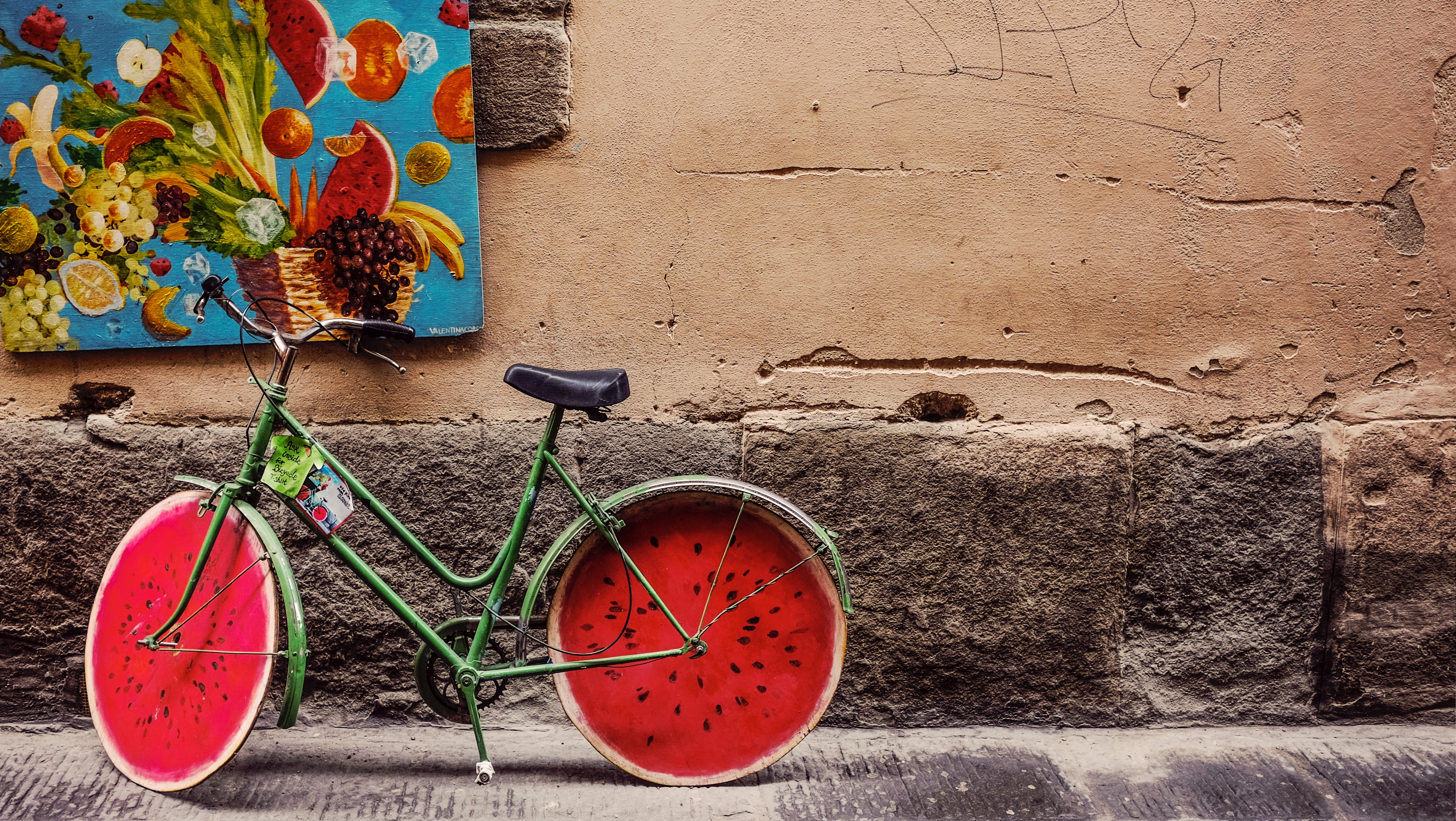 Green bicycle with watermelon slice wheels